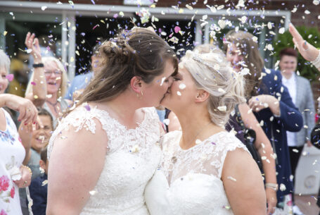 Great confetti image where all guests are throwing at the same time. Photo by John Fox Wedding Photography.