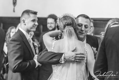 Weddings at Peckforton Castle. Guest congratulating the bride