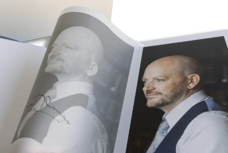 Manor by the Lake-Wedding Album showing the translucent printed page of the groom