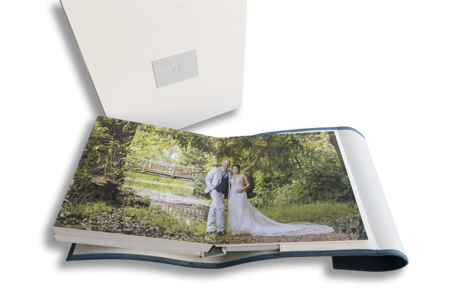 Manor by the Lake-Wedding Album showing the bride and groom in the gardens by the lake and bridge