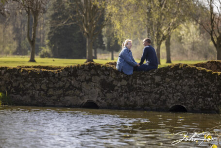 Bride and groom to be on their pre-wedding shoot sitting on a bridge at Branston Golf and Country Club