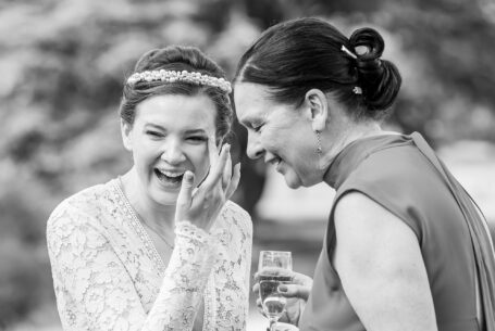 Laughter captured between the bride and her mother-in-law