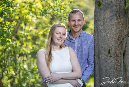 Happy couple on their pre wedding shoot at Ansty Hall in wooded area