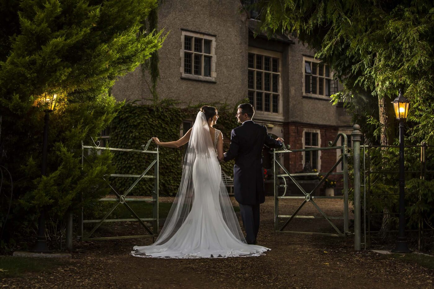 Posed style wedding images in today's world. The wedded couple opening gates together.