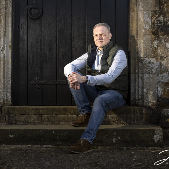 Lee the groom-to-be on the steps at St Mary Magdalene Church in Cottingham. Image by John Fox Wedding Photography.
