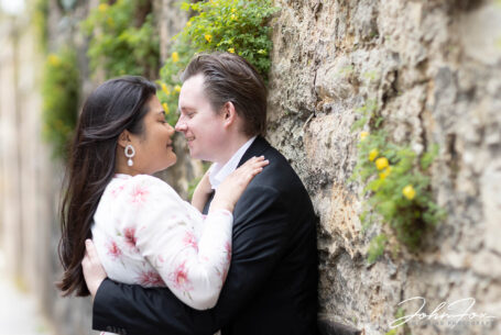 Bride and groom-to-be about to kiss against a wall