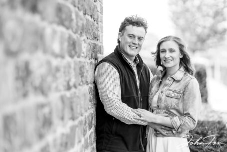 Pre-wedding photograph of the couple by one of the barns at Primrose Hill Farm