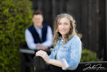 Image of the bride to be with groom in the background by John Fox Wedding Photography