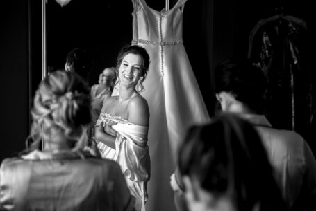 The bride laughing with her bridesmaids