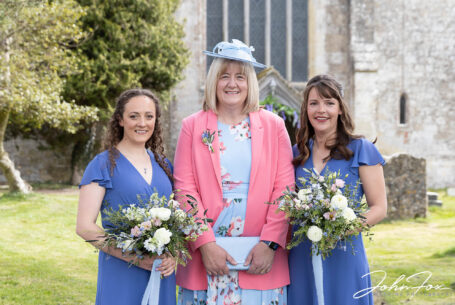 Bride's mum and bridesmaids outside St John the Baptist Church in Tisbury