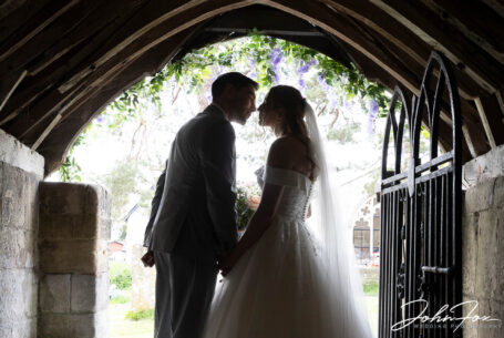 Bride and groom in the church doorway at Tisbury, Wiltshire