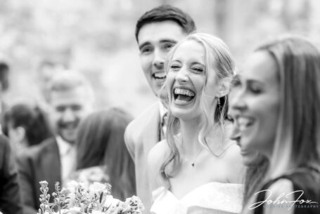 Wedding photography Wiltshire. Natural image of bride and groom with guests