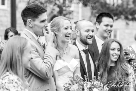 Wedding photography Wiltshire. Natural image of bride and groom with guests