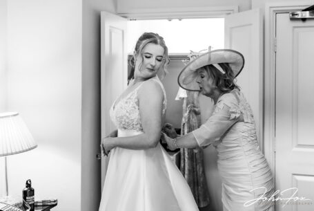 Ansty Hall Wedding Photography. Mum helping the bride with her dress