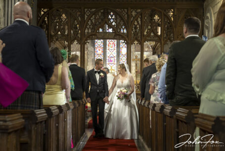 Bride and groom walking down the aisle
