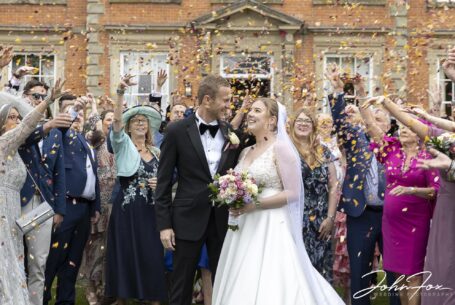 Bride and groom confetti image in front of Ansty Hall, Coventry. Image by John Fox Wedding Photography
