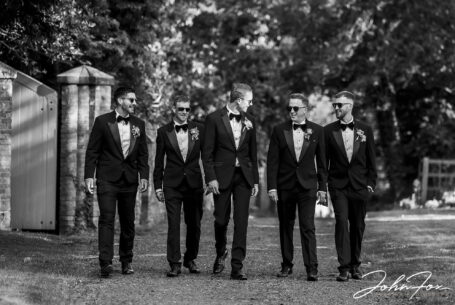 Groom and groomsmen walking to St James' Church