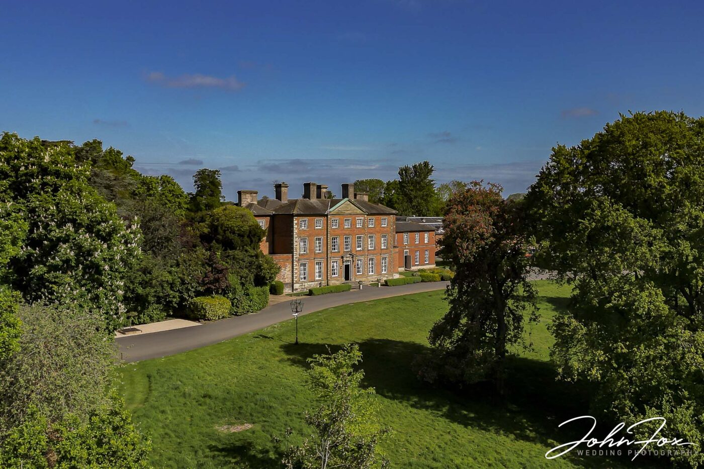 Ansty Hall Wedding Photography by Recommended Photographer. Stunning image of the wedding venue under a blue sky.