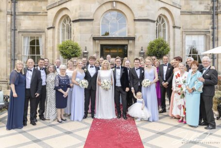 Bride and groom with all the guests at Grantley Hall. Wedding Photography by John Fox.