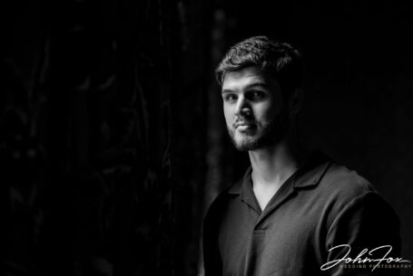 Groom photographed on the pre-wedding shoot indoors by a window at Kilworth House