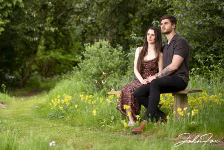 Couple photographed on their pre-wedding sitting on a bench at Kilworth House, Leicestershire