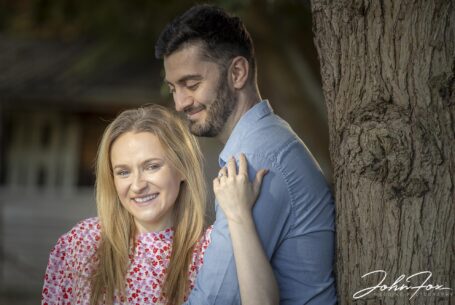 pre-wedding shoot image of the bride and groom by a tree at their Warwickshire family home.