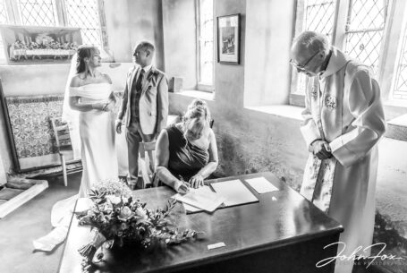Witness signing the wedding registrar at St Mary Magdalene Church