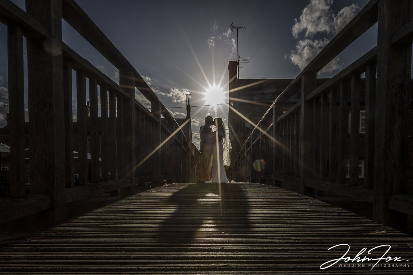 Wedding Photography for Emma and Lee in Leicestershire. Sunlight dazzling between the happy couple captured by John Fox