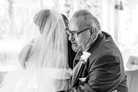 Wedding Photography in Buckinghamshire. Bride and father embracing as he sees her for the first time in her wedding dress.