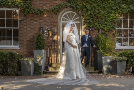 Wedding Photography in Buckinghamshire. Bride with groom in the background.