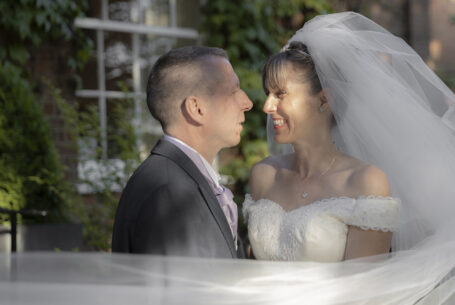 Wedding Photography in Buckinghamshire. Bride and groom, her veil caught by the breeze.