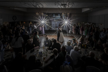 Bride and groom at their Milton Keynes' wedding. Their first dance surrounded by their guests.