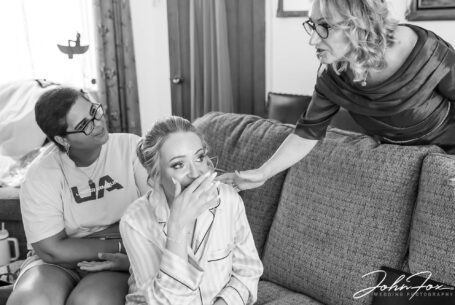 Bridal preparations mum with emotional bride. Local Warwickshire Wedding Photographer, John Fox