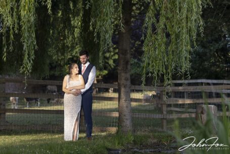 Bride and groom pictured in a pool of sunlight at their Warwickshire wedding