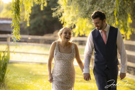 Relaxed fun image of bride and groom in evening light. Local Warwickshire Wedding Photographer, John Fox