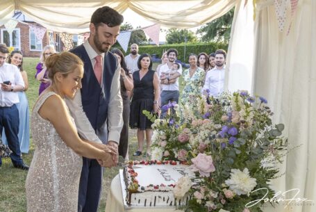Bride and groom cutting the cake at their Warwickshire Wedding