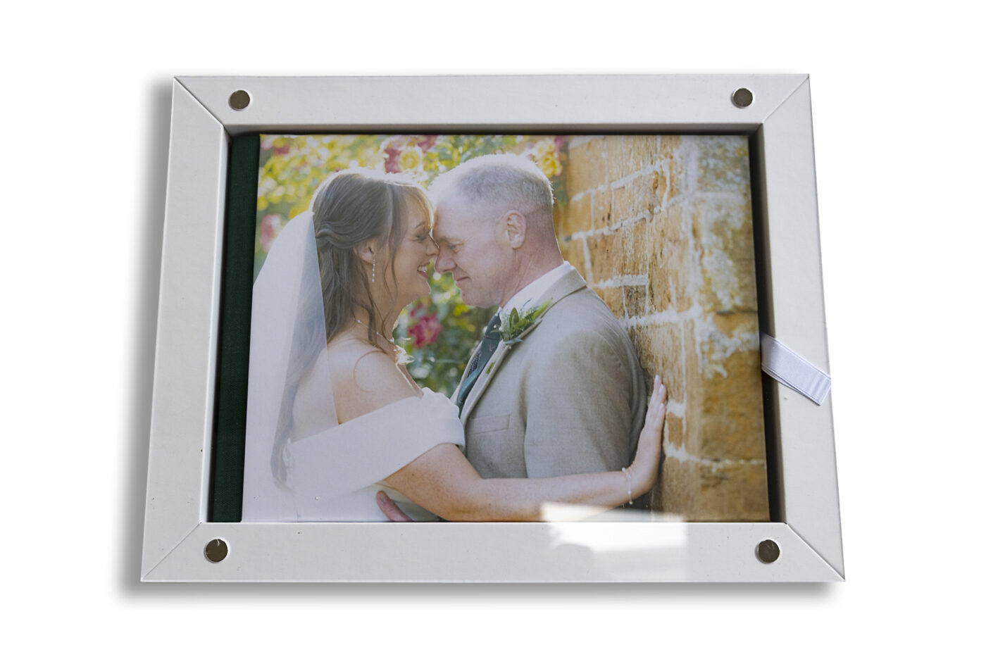 Handcrafted wedding album. The bride and groom on the front cover at their Leicestershire wedding reception.