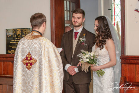 Wedding ceremony bride and groom with priest