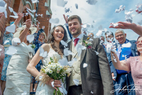 Bride and groom showered in confetti