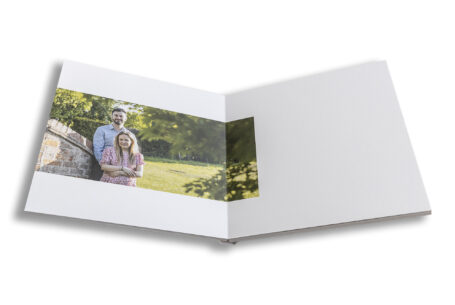 Unique bespoke wedding guest book for a Warwickshire wedding. The couple outside the venue.