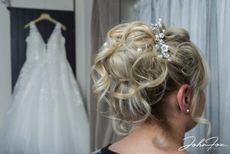 Wedding Photographer in Staffordshire. Bride's hair with wedding dress in the background.