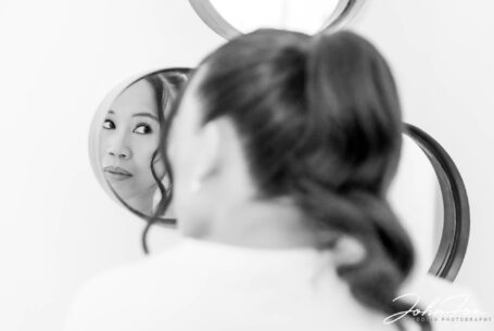 Bridesmaid reflected in mirror at Tortworth Court in Gloucestershire