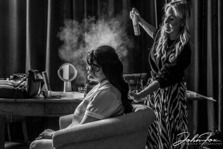 Wedding Photography at Tortworth Court in Gloucestershire. Bride and the hairspray image in black and white.