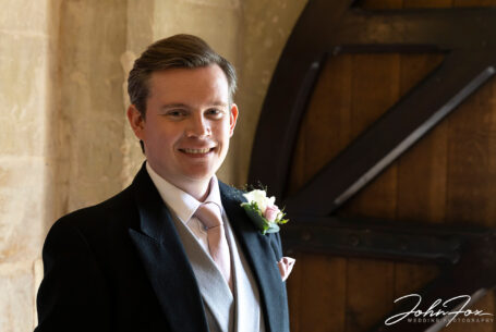 Groom at the church door image taken using natural light. Woodchester Priory, Stroud.