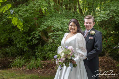 Bride and groom in trees and natural light. Image by John Fox Wedding Photography.