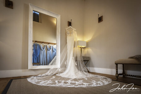 Wedding dress and bridesmaid dresses hanging up at Primrose Hill Farm