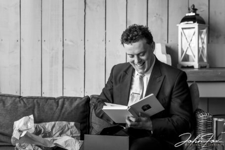 Image of the groom with a gift from the bride.