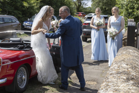 Bride arriving with father and bridesmaids at an Oxfordshire wedding.