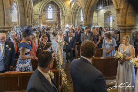 Bride being walked up the aisle by her dad. Image by John Fox.