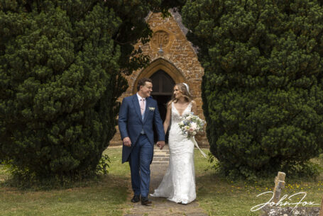 Bride and groom walking out of Radway Church, St Peter’s